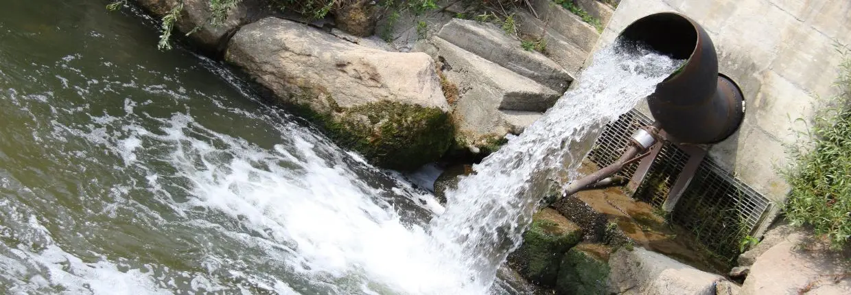 Un tubi di scarico in un fiume